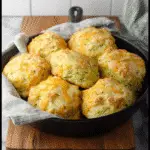 zucchini cheddar biscuits on rustic table