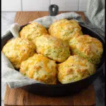 zucchini cheddar biscuits on rustic table