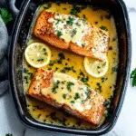 Garlic butter baked salmon on white plate