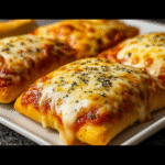 Cheesy pizza pockets on parchment paper