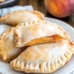 Peach Hand Pies stacked with fresh peaches