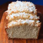 Coconut bread loaf sliced on board